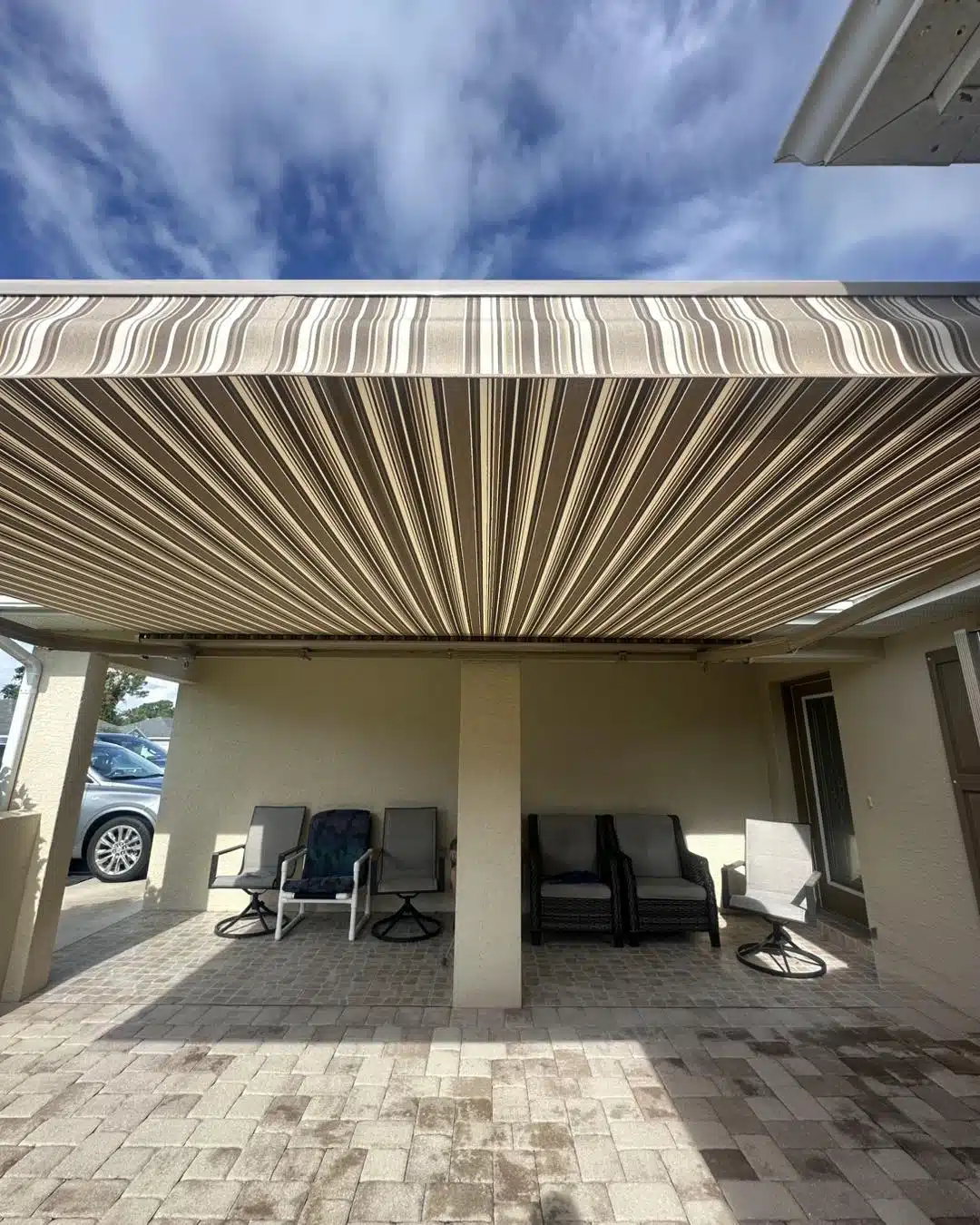 Before and after garage transformation with Urban Shadeworks motorized retractable screen in Lakeland, FL