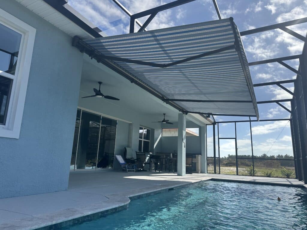 Homeowner enjoying comfortable outdoor space under motorized awning during Florida peak sun hours