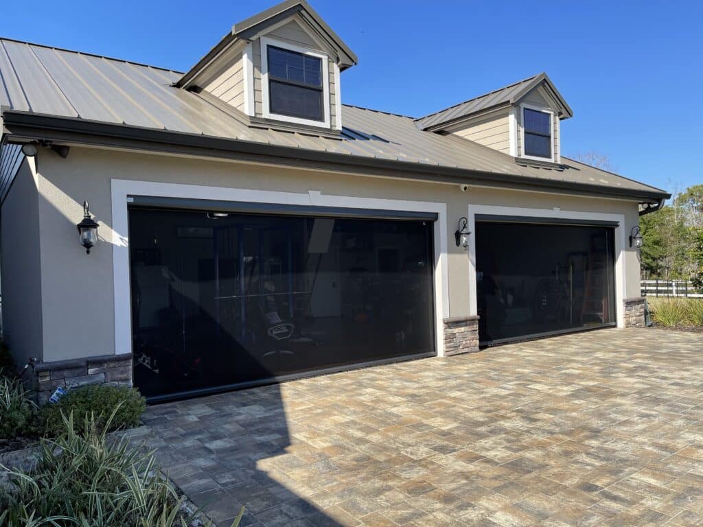 Comfortable garage workshop with motorized retractable screen in Lakeland Florida